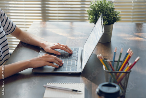 Woman hand using laptop and type on the keyboard, Mockup screen of advertisement.