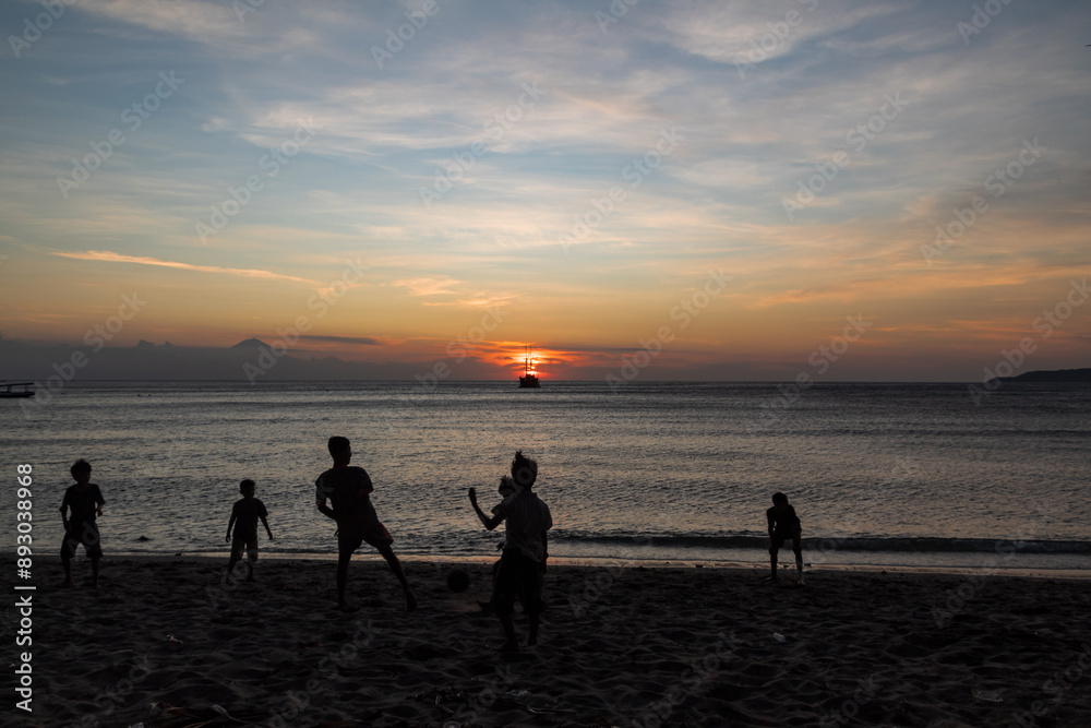 silhouette of family people playing on the beach with sunset background silhouette of family people playing on the beach with sunset background