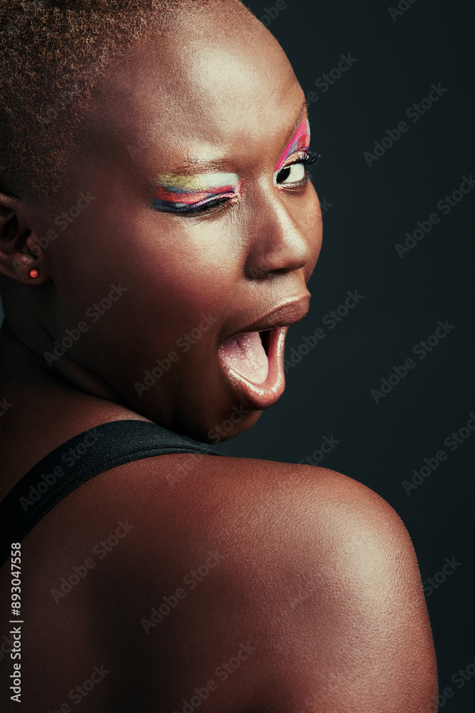 Black woman, wink and happy in studio for makeup, beauty or cosmetics for self care. Model girl, mouth and wow or expression for eyeshadow, art deco or aesthetics for glow or shine by dark background Black woman, wink and happy in studio for makeup, beauty or cosmetics for self care. Model girl, mouth and wow or expression for eyeshadow, art deco or aesthetics for glow or shine by dark background