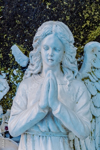 Broken bust of an angel statue smashed on the ashphat. The hands are in prayer position. Old Town, Albuquerque, New Mexico, United States Of America. photo