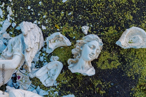 Broken bust of an angel statue smashed on the ashphat. Old Town, Albuquerque, New Mexico, United States Of America. photo