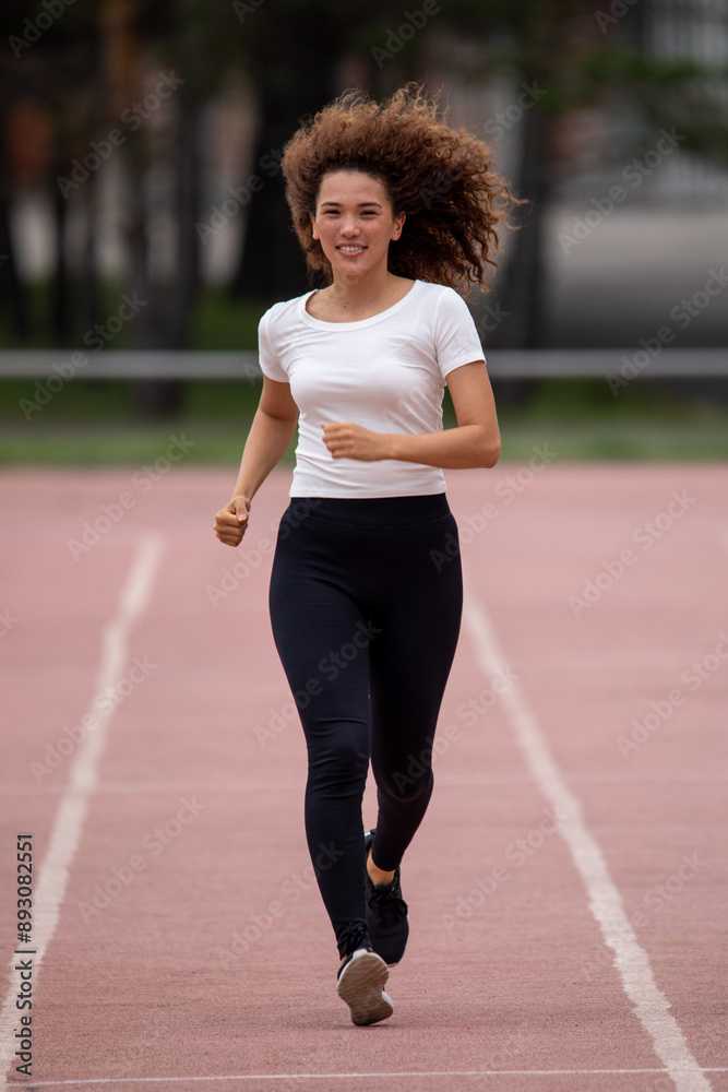 Beautiful curly Asian woman running on the street Beautiful curly Asian woman running on the street