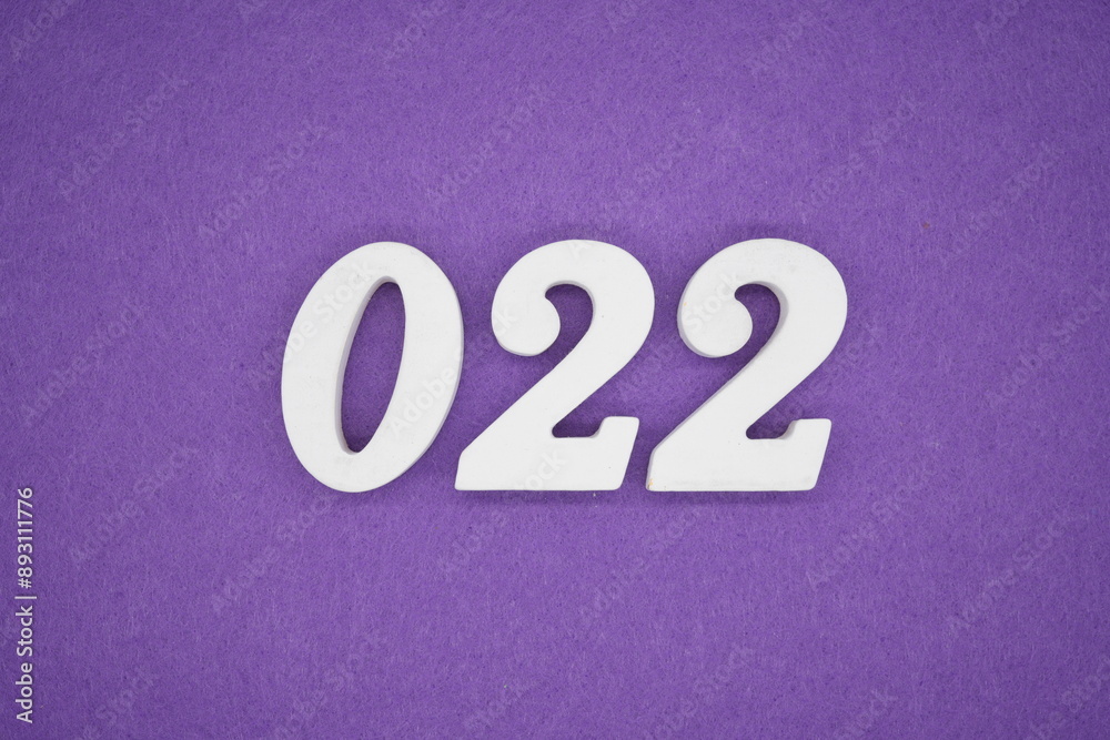 The numbers are made of white paint wood, placed on the background as a purple paper. The numbers are made of white paint wood, placed on the background as a purple paper.
