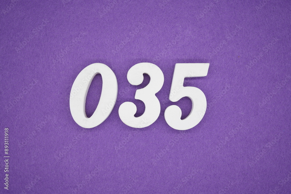 The numbers are made of white paint wood, placed on the background as a purple paper. The numbers are made of white paint wood, placed on the background as a purple paper.