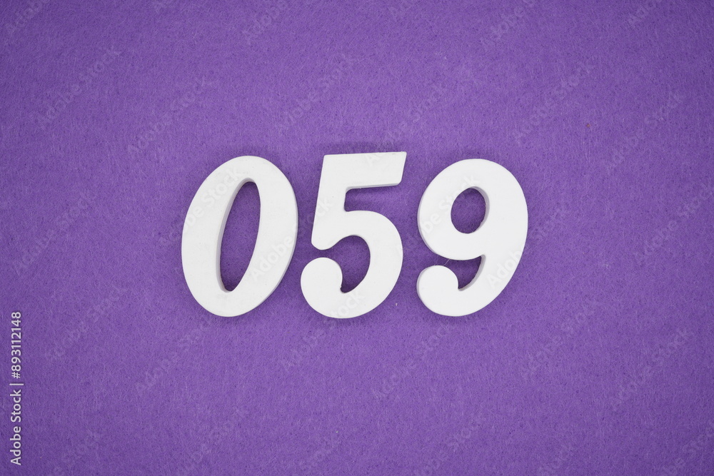 The numbers are made of white paint wood, placed on the background as a purple paper. The numbers are made of white paint wood, placed on the background as a purple paper.