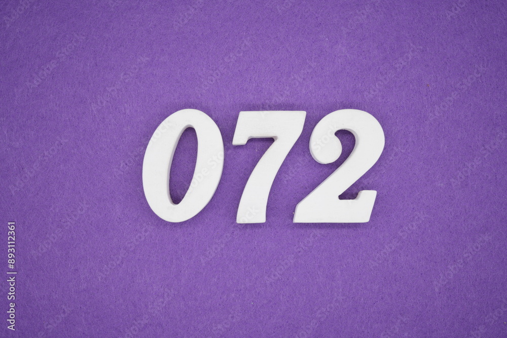 The numbers are made of white paint wood, placed on the background as a purple paper. The numbers are made of white paint wood, placed on the background as a purple paper.