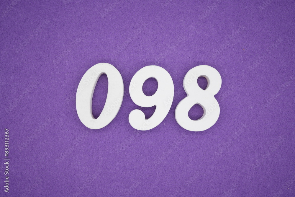 The numbers are made of white paint wood, placed on the background as a purple paper. The numbers are made of white paint wood, placed on the background as a purple paper.