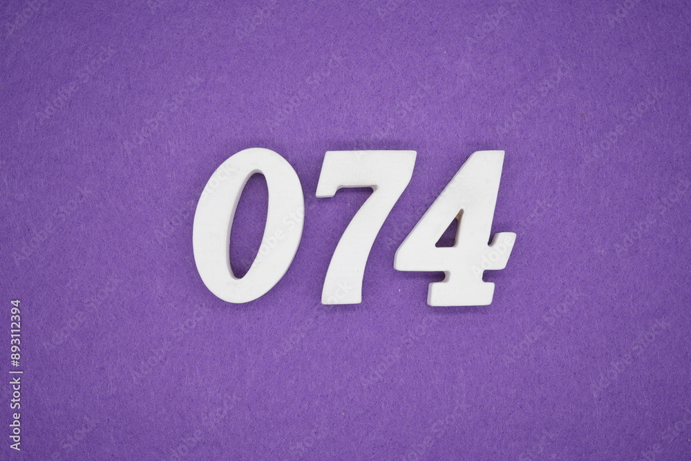 The numbers are made of white paint wood, placed on the background as a purple paper. The numbers are made of white paint wood, placed on the background as a purple paper.