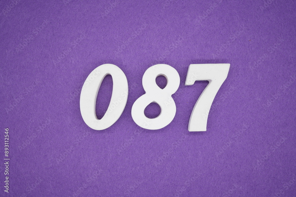The numbers are made of white paint wood, placed on the background as a purple paper. The numbers are made of white paint wood, placed on the background as a purple paper.