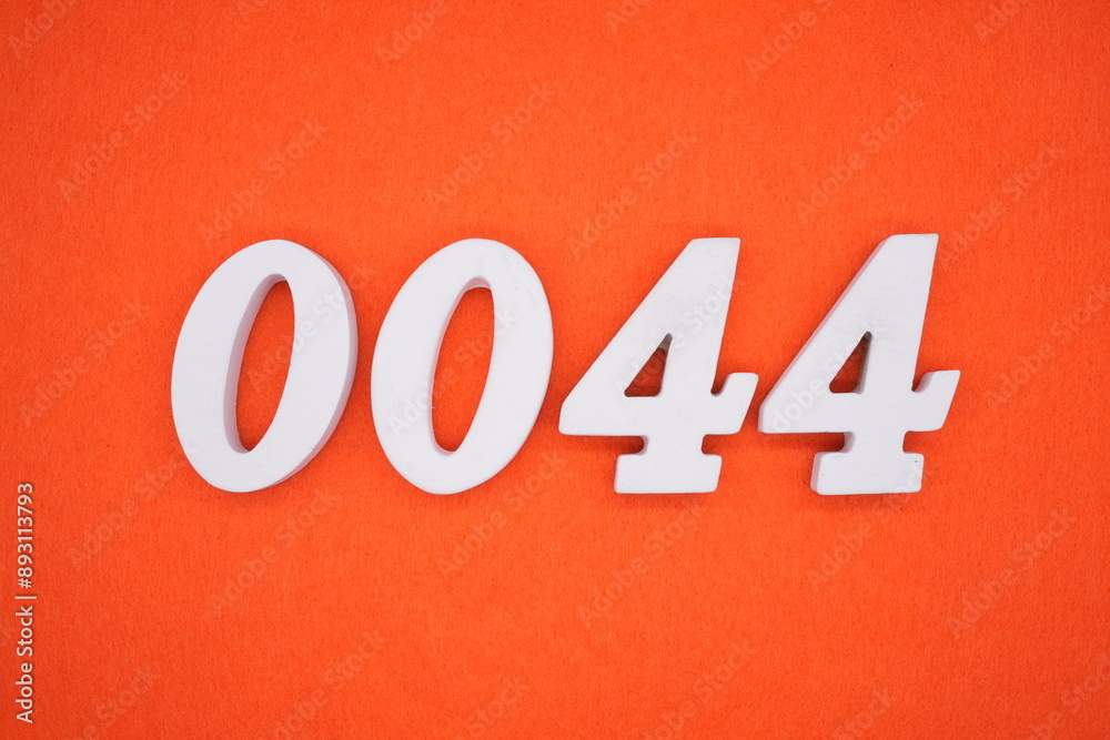 The numbers are made of white painted wood. Placed on the floor was orange paper. The numbers are made of white painted wood. Placed on the floor was orange paper.