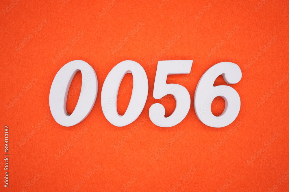 The numbers are made of white painted wood. Placed on the floor was orange paper. The numbers are made of white painted wood. Placed on the floor was orange paper.