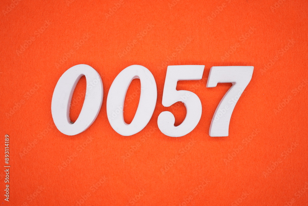 The numbers are made of white painted wood. Placed on the floor was orange paper. The numbers are made of white painted wood. Placed on the floor was orange paper.