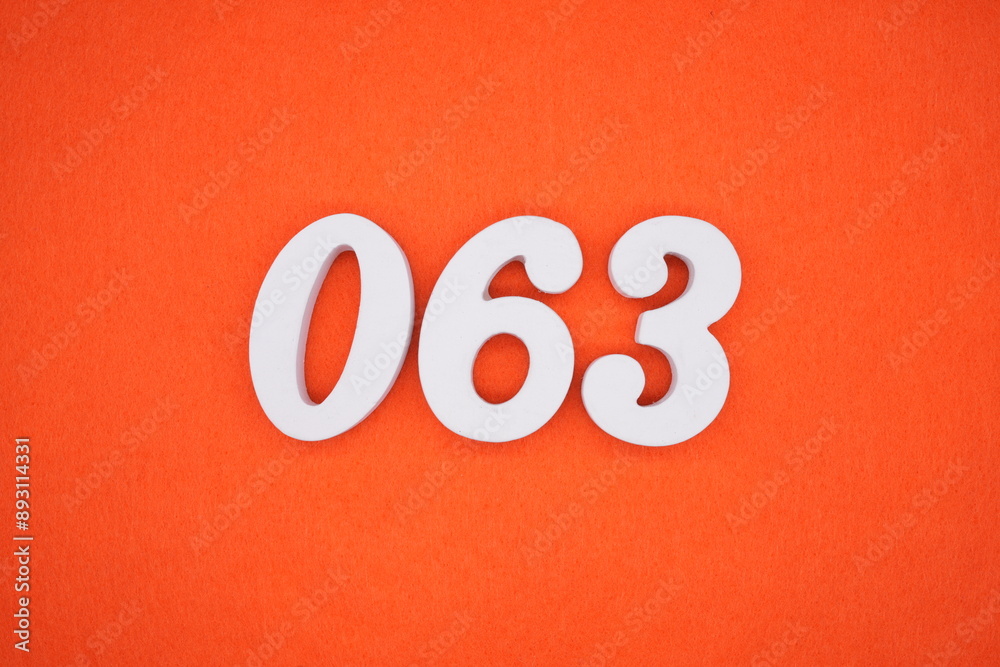 The numbers are made of white painted wood. Placed on the floor was orange paper. The numbers are made of white painted wood. Placed on the floor was orange paper.