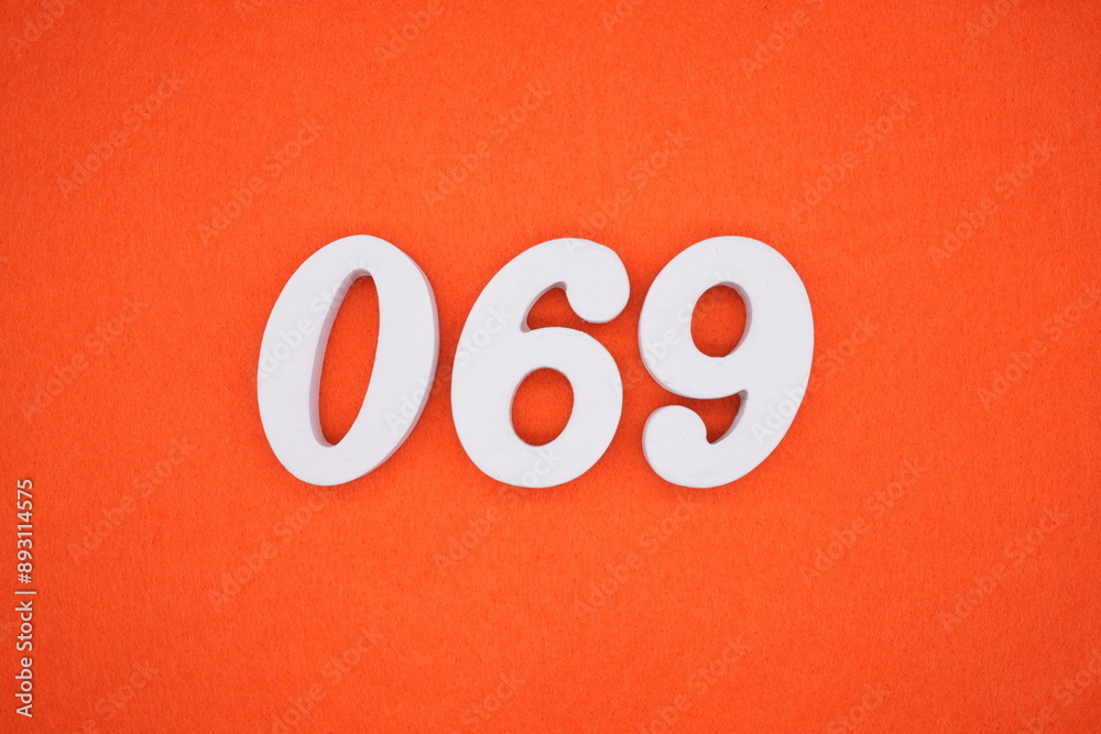 The numbers are made of white painted wood. Placed on the floor was orange paper. The numbers are made of white painted wood. Placed on the floor was orange paper.