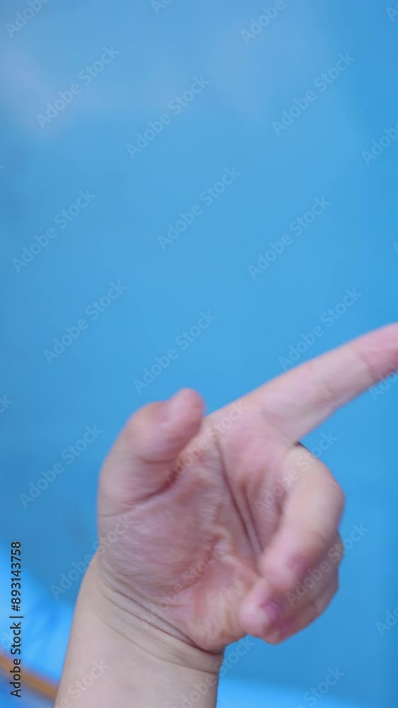 kid child hands against pool with wrinkles after long bath or swim. kid child hands against pool with wrinkles after long bath or swim.