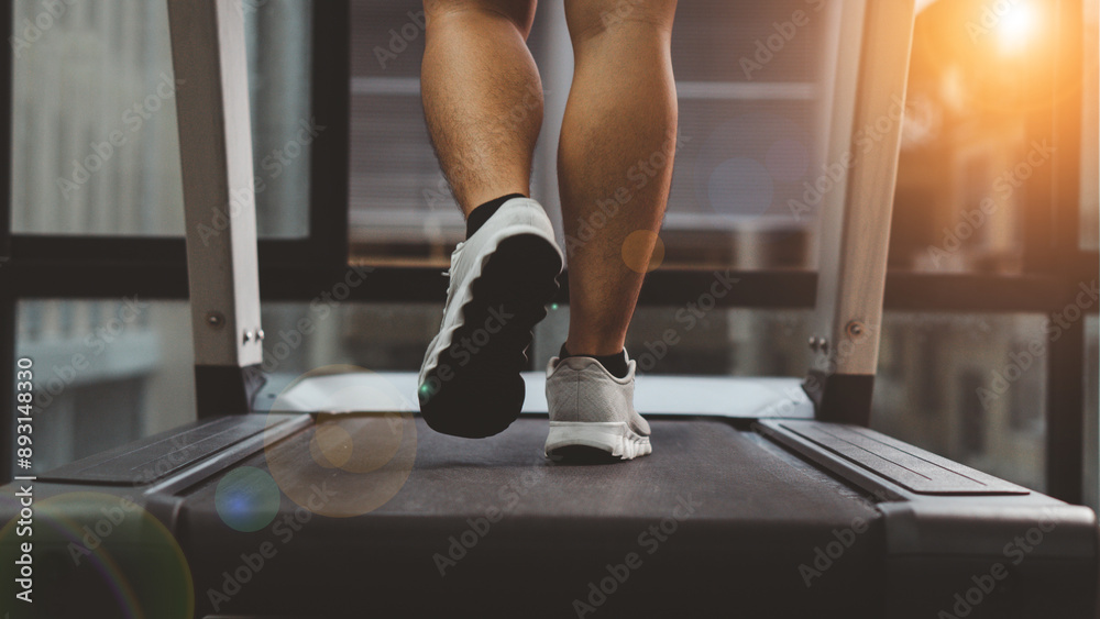 Close up photo of male feet on a treadmill. Cardio. he is running on treadmill in fitness. Man exercising in the gym. Close up photo of male feet on a treadmill. Cardio. he is running on treadmill in fitness. Man exercising in the gym.