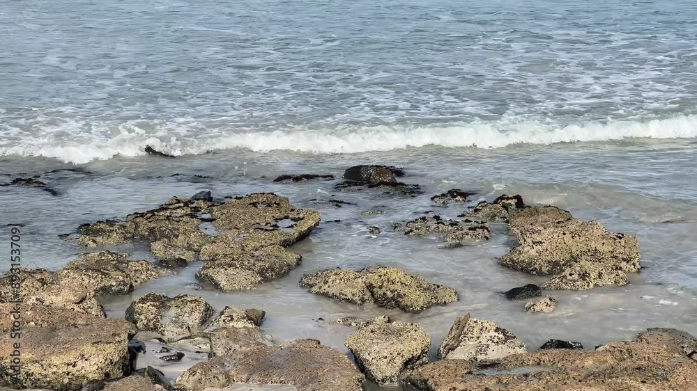 Beach rocks being covered by seawater as the tide is coming in Beach rocks being covered by seawater as the tide is coming in
