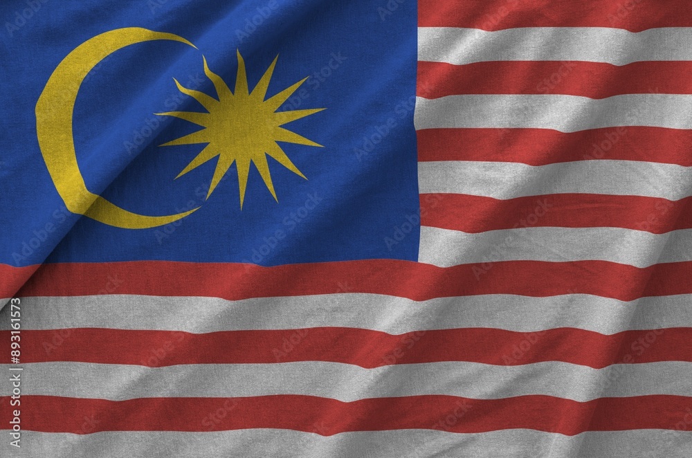 Malaysia flag depicted on folded wavy fabric of old cloth close up Malaysia flag depicted on folded wavy fabric of old cloth close up