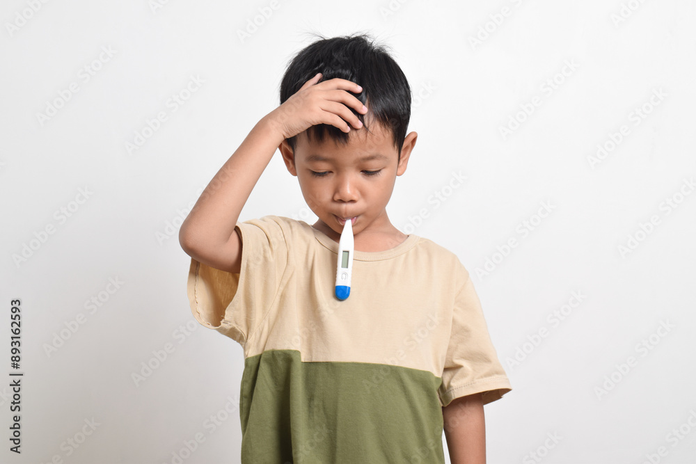 Little Asian boy is sick with thermometer in mouth and hand on forehead isolated on white background. healthcare concept. Little Asian boy is sick with thermometer in mouth and hand on forehead isolated on white background. healthcare concept.