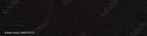 Obraz na płótnie Black stained oak veneer surface with a subtle yet captivating wood grain texture w salonie