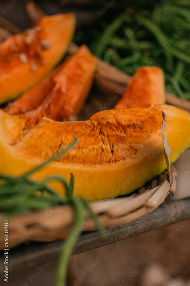 Pumpkin in basket with green beans at a farmers market in Mauritius.