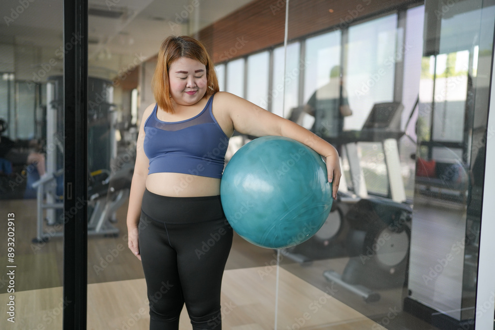 Obese asian woman exercising hold ball fitness workout and health concept. training working out. Obese asian woman exercising hold ball fitness workout and health concept. training working out.