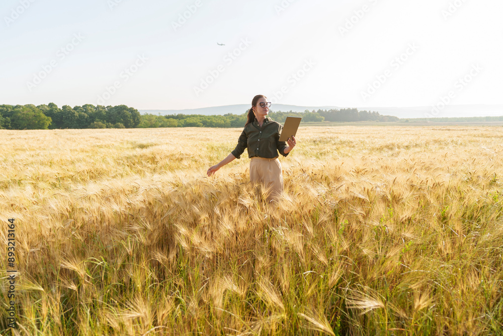 Agronomist using tablet PC standing in barley field Agronomist using tablet PC standing in barley field