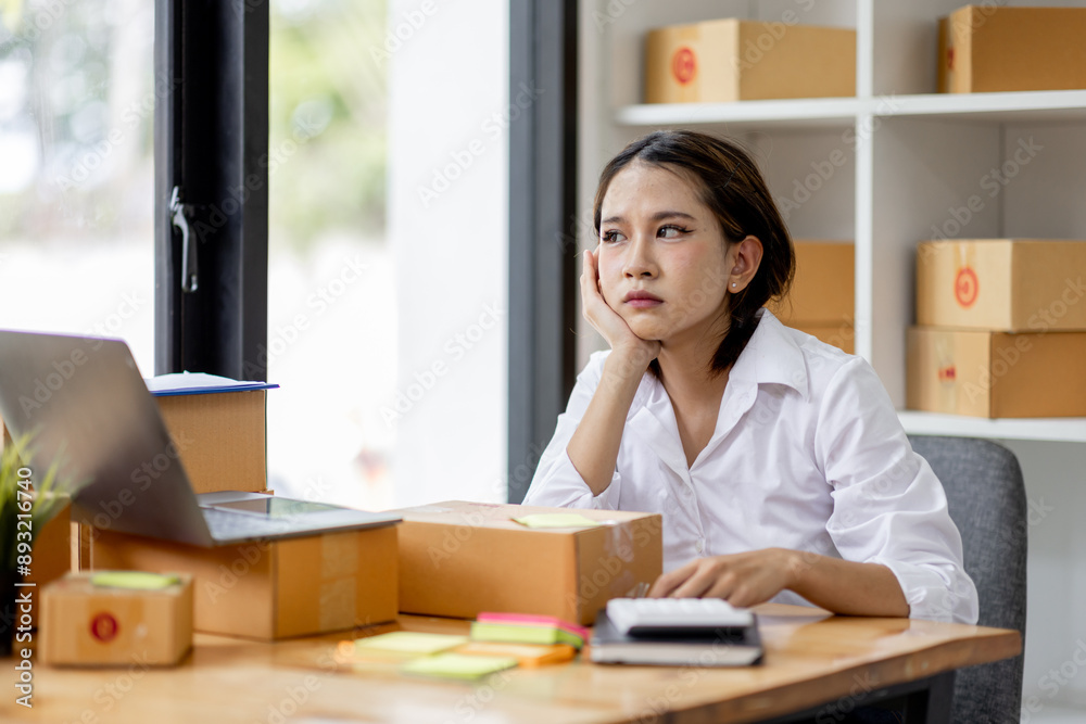 Asian woman think hard serious working of sme laptop computer at home selling online start up small business owner, e-commerce ideas concept. Asian woman think hard serious working of sme laptop computer at home selling online start up small business owner, e-commerce ideas concept.