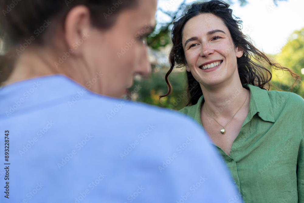 Smiling woman talking with friend at street Smiling woman talking with friend at street