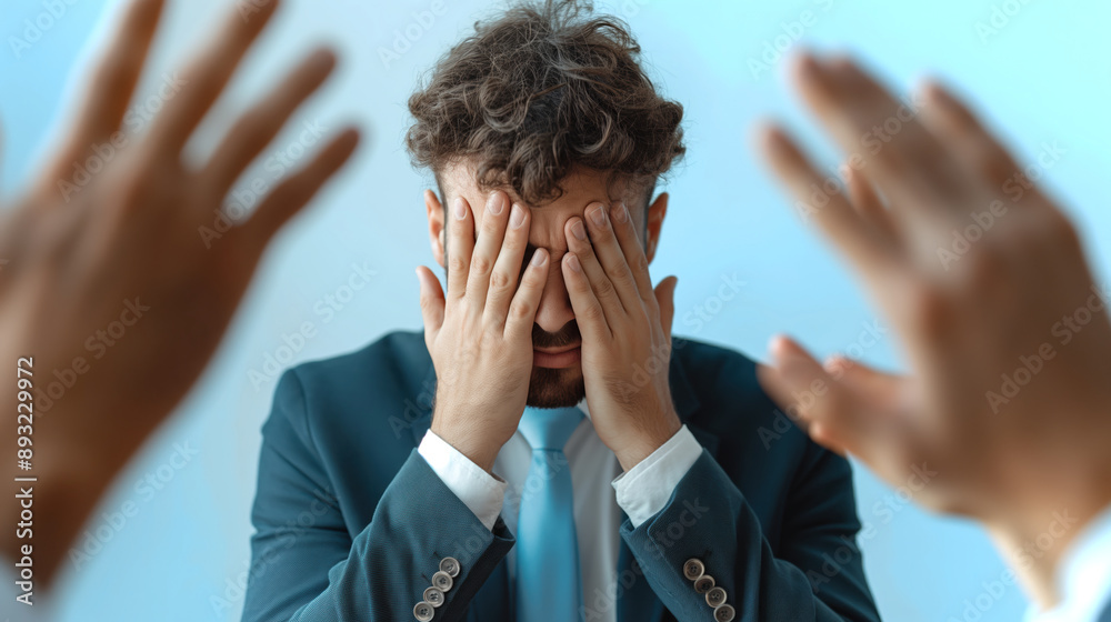 Stressed Businessman Covering His Eyes with Hands in Corporate Environment Stressed Businessman Covering His Eyes with Hands in Corporate Environment