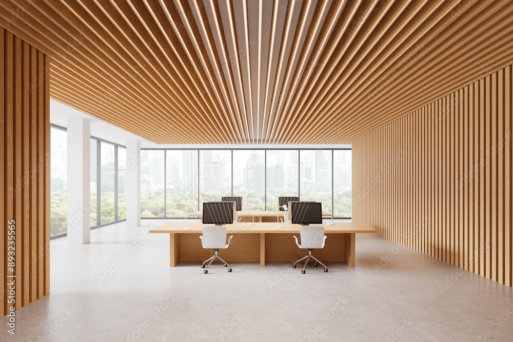 Fototapeta premium Modern office with a wooden interior featuring desks, chairs, and computers. Bright, natural light coming through large windows. Work environment concept. 3D rendering