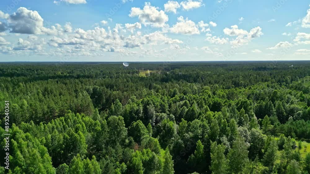 Aerial shot of Irbene radio telescope in latvia surrounded by trees, far away Aerial shot of Irbene radio telescope in latvia surrounded by trees, far away