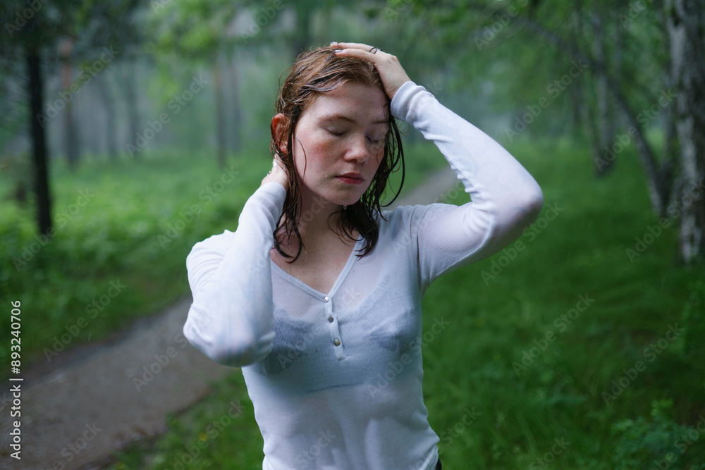 Young woman with eyes closed and hand in hair at forest Young woman with eyes closed and hand in hair at forest