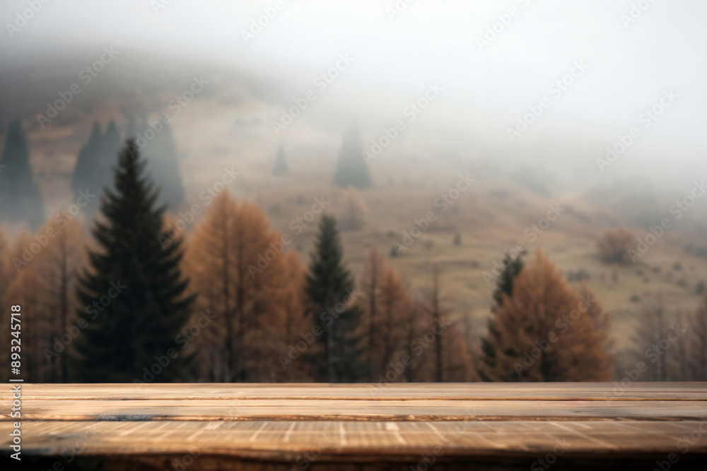 Empty wooden tabletop with a blurred autumn forest and misty mountains as background Empty wooden tabletop with a blurred autumn forest and misty mountains as background