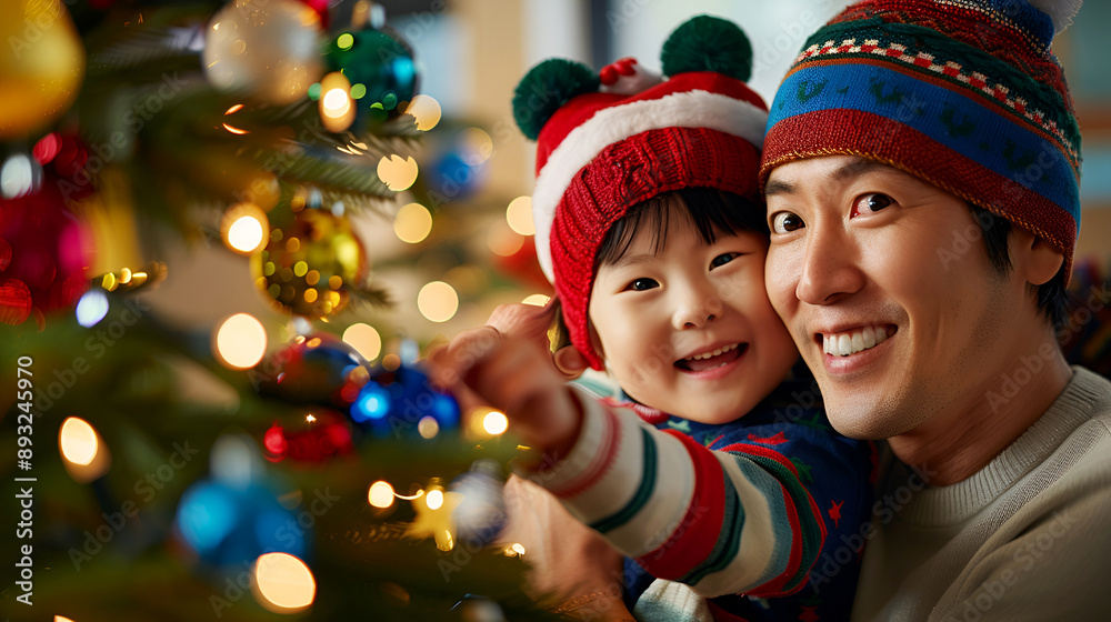 Happy Asian father and daughter in colorful hats decorating a Christmas tree, celebrating the festive season with joy and togetherness. Happy Asian father and daughter in colorful hats decorating a Christmas tree, celebrating the festive season with joy and togetherness.