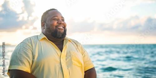 A handsome overweight man smiling on a summer beach vacation, enjoying the shore and ocean views.