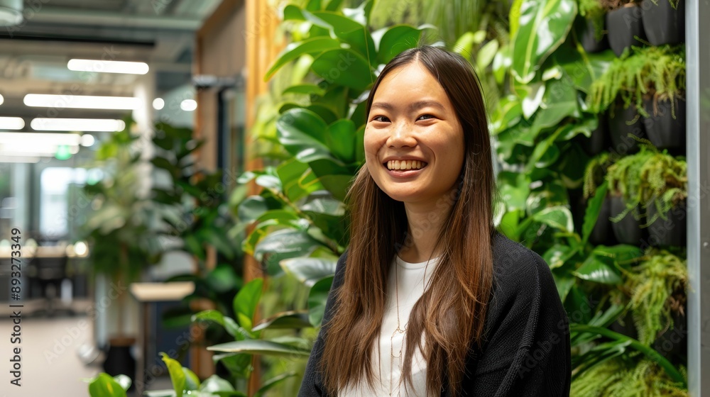 Smiling professional in a contemporary office with green plants Smiling professional in a contemporary office with green plants