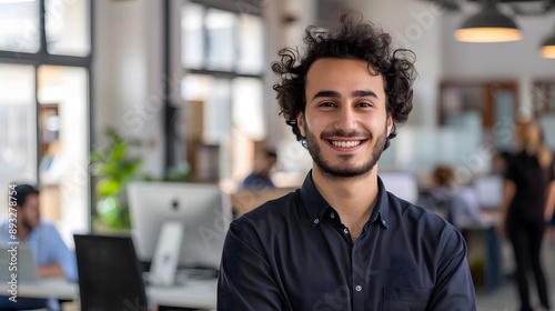 Young Arabic Model in Smart Outfit Smiling at Office Desk