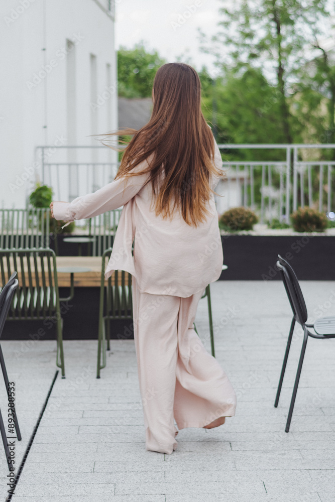 Portrait of a young caucasian girl smiling and enjoying life on the roof.