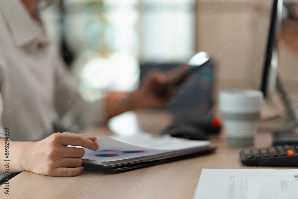 Fototapeta premium Businesswoman working with data spreadsheet documents at workplace
