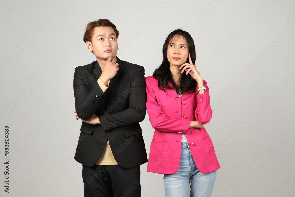 portrait of pensive asian Indonesian business man and woman with thinking gesture on isolated background portrait of pensive asian Indonesian business man and woman with thinking gesture on isolated background