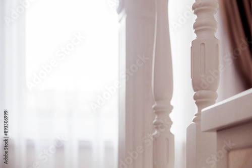 Detailed White Stair Spindle Close-Up. A close-up view of a white staircase spindle with intricate design details.