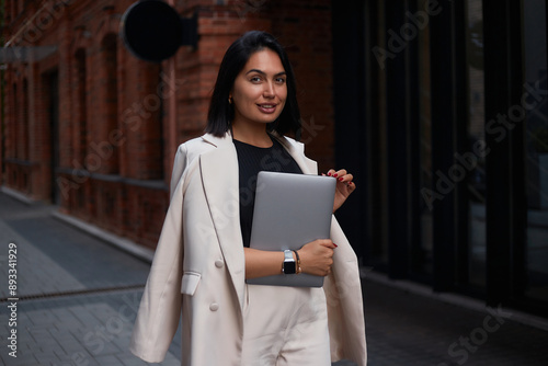 business woman in a suit works during rush hour. a young girl hurries to a meeting. young entrepreneur. freelancer. successful business