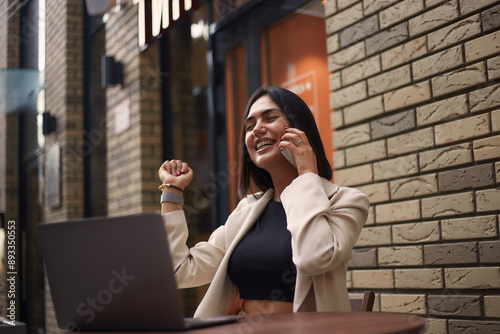 Young happy lucky female student feeling like excited winner while holding mobile phone. Successful businesswoman. freelancer. emotions