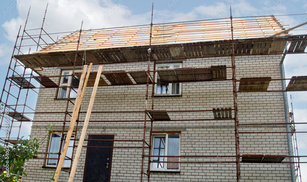 Roof repair of a private residential building. Roof with sheathing for subsequent covering with iron tiles Roof repair of a private residential building. Roof with sheathing for subsequent covering with iron tiles