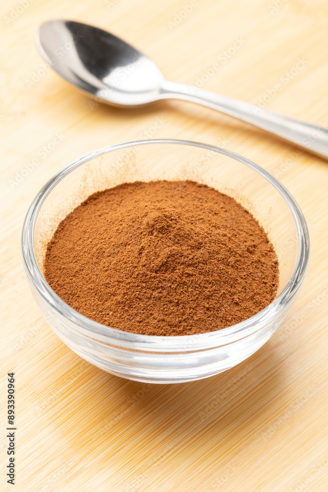 Glass bowl with aromatic ground cinnamon close up Glass bowl with aromatic ground cinnamon close up