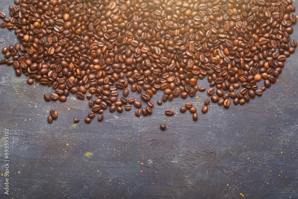 Roasted coffee beans on rustic slate, space for copying