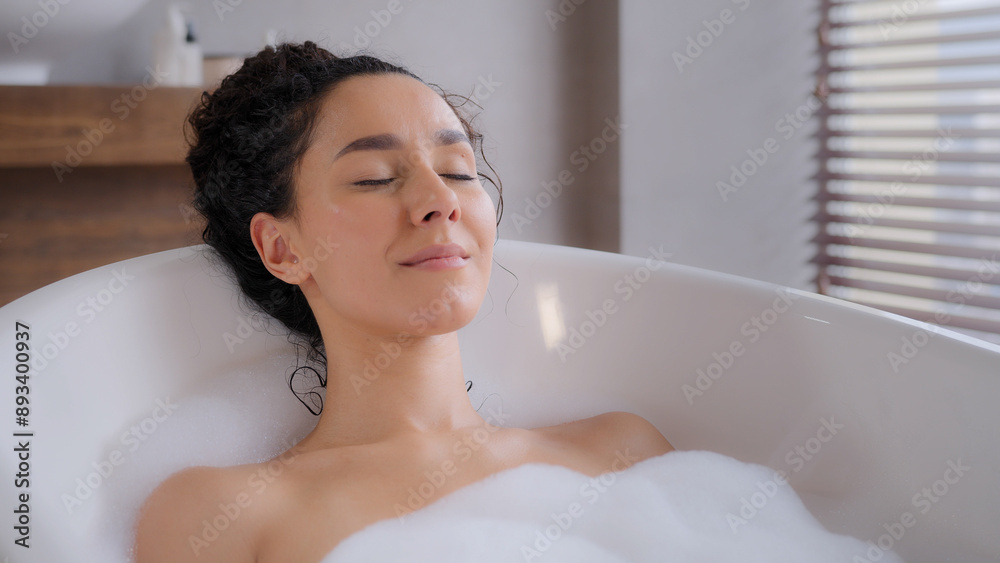 Close-up young attractive relaxed woman lying in hot foam bath with eyes closed resting relaxing in bathroom happy carefree pensive dreamy girl enjoying daily hygiene routine bathing washes bodycare Close-up young attractive relaxed woman lying in hot foam bath with eyes closed resting relaxing in bathroom happy carefree pensive dreamy girl enjoying daily hygiene routine bathing washes bodycare