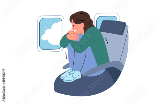 Aerophobia in woman flying in airplane, encountered turbulence, and sitting with legs up in passenger seat of airliner. Problem of aerophobia in girl experiencing panic due to fear of heights