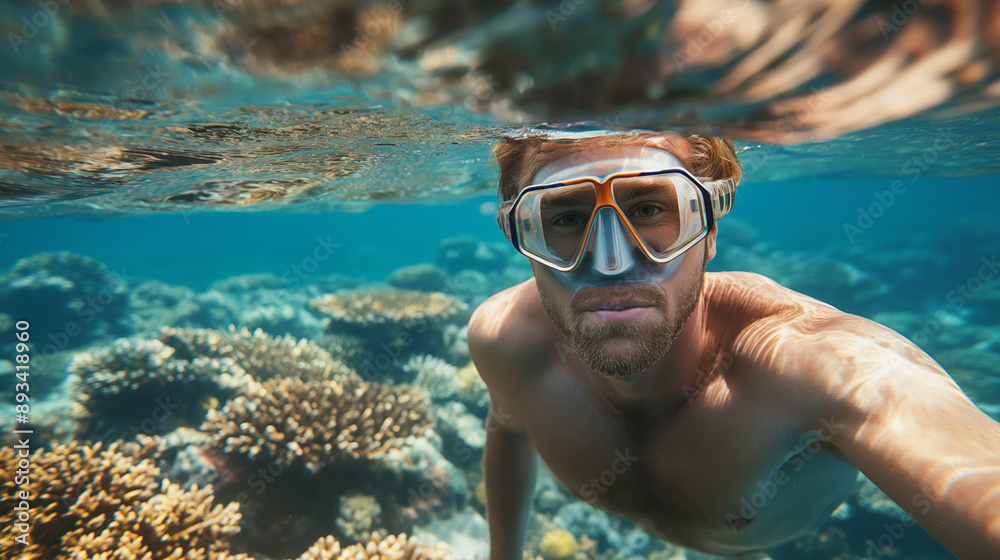 Naklejka premium Man Snorkeling in Clear Ocean Water with Coral Reefs.